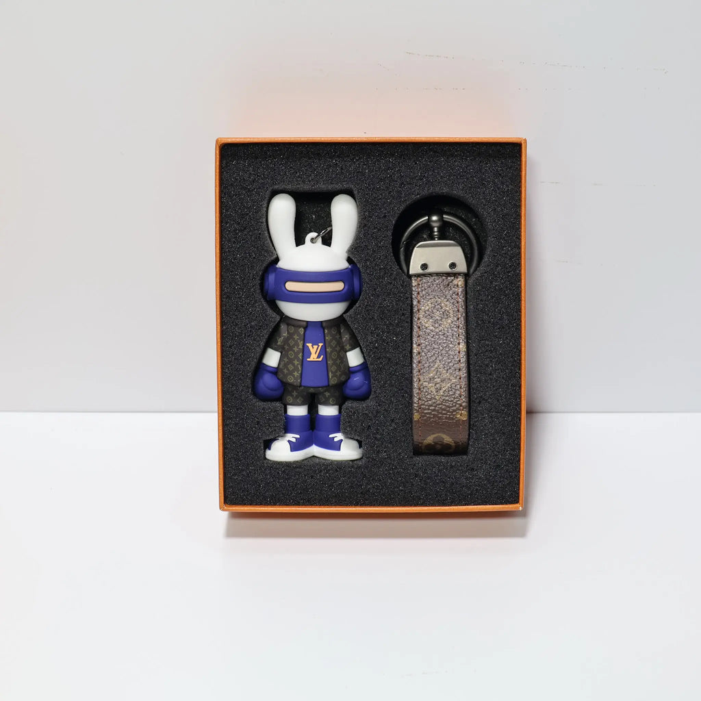 Blue and white rabbit keychain with monogram strap in a box
