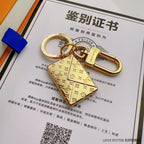 Gold-tone envelope keychain with engraved monogram and swivel clasp