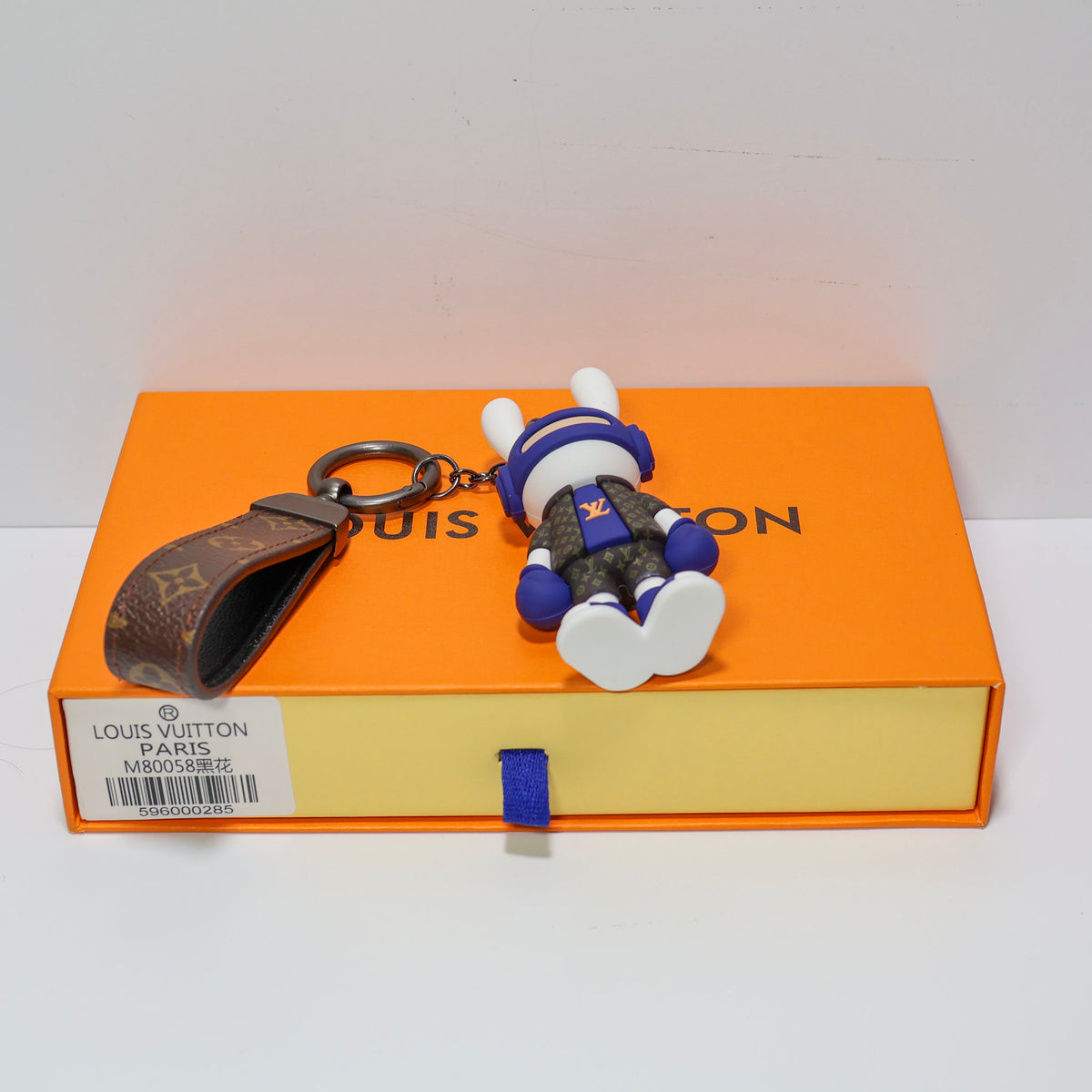 Front view of rabbit keychain lying flat with white soles