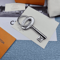 Silver-tone key-shaped charm with oval head and LV detail