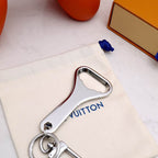 Reverse of silver-tone bottle opener showing curved opening