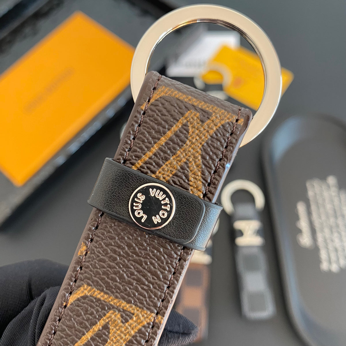 Brown monogram key holder showing rear fastening and keyring