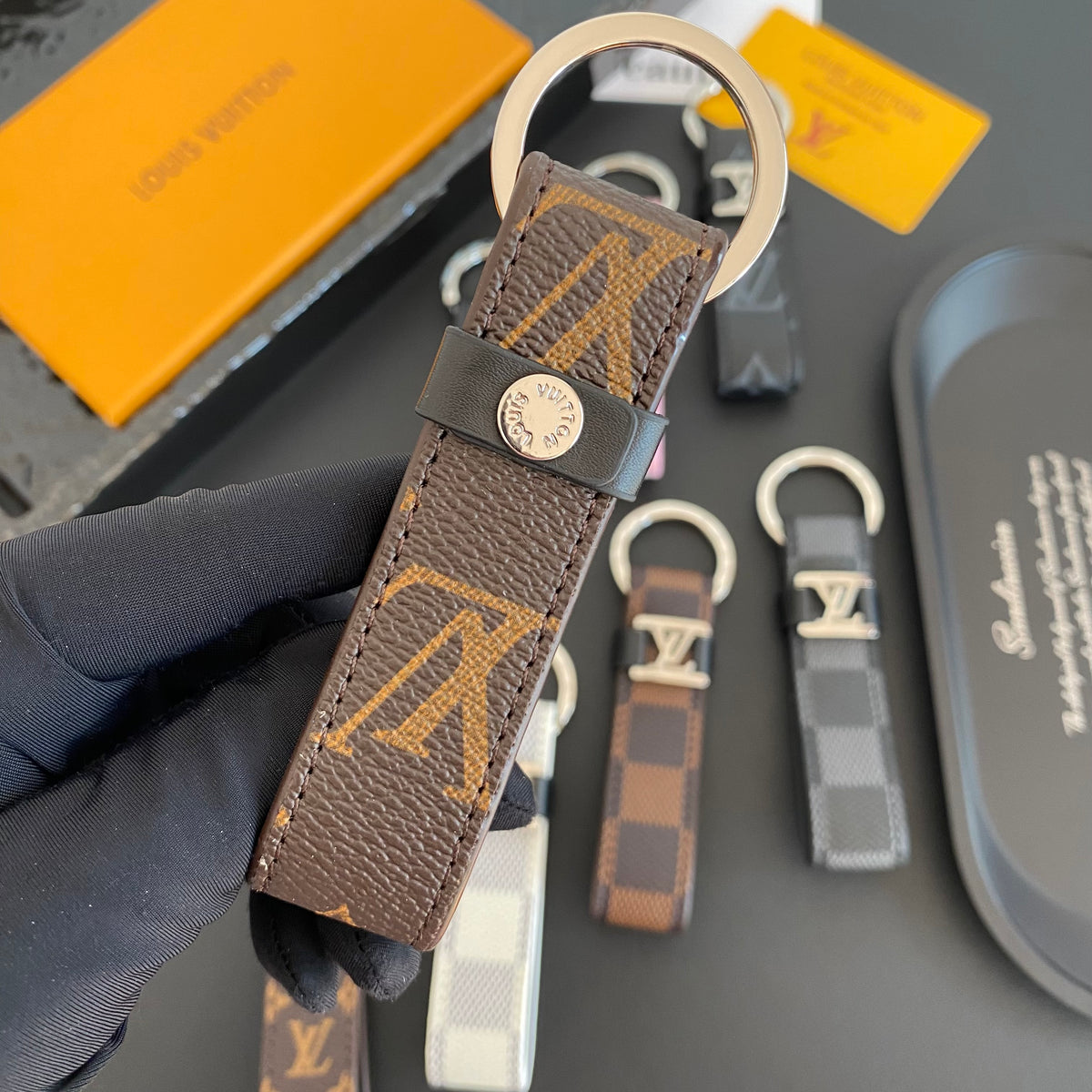 Reverse of brown monogram strap showing round fastening stud