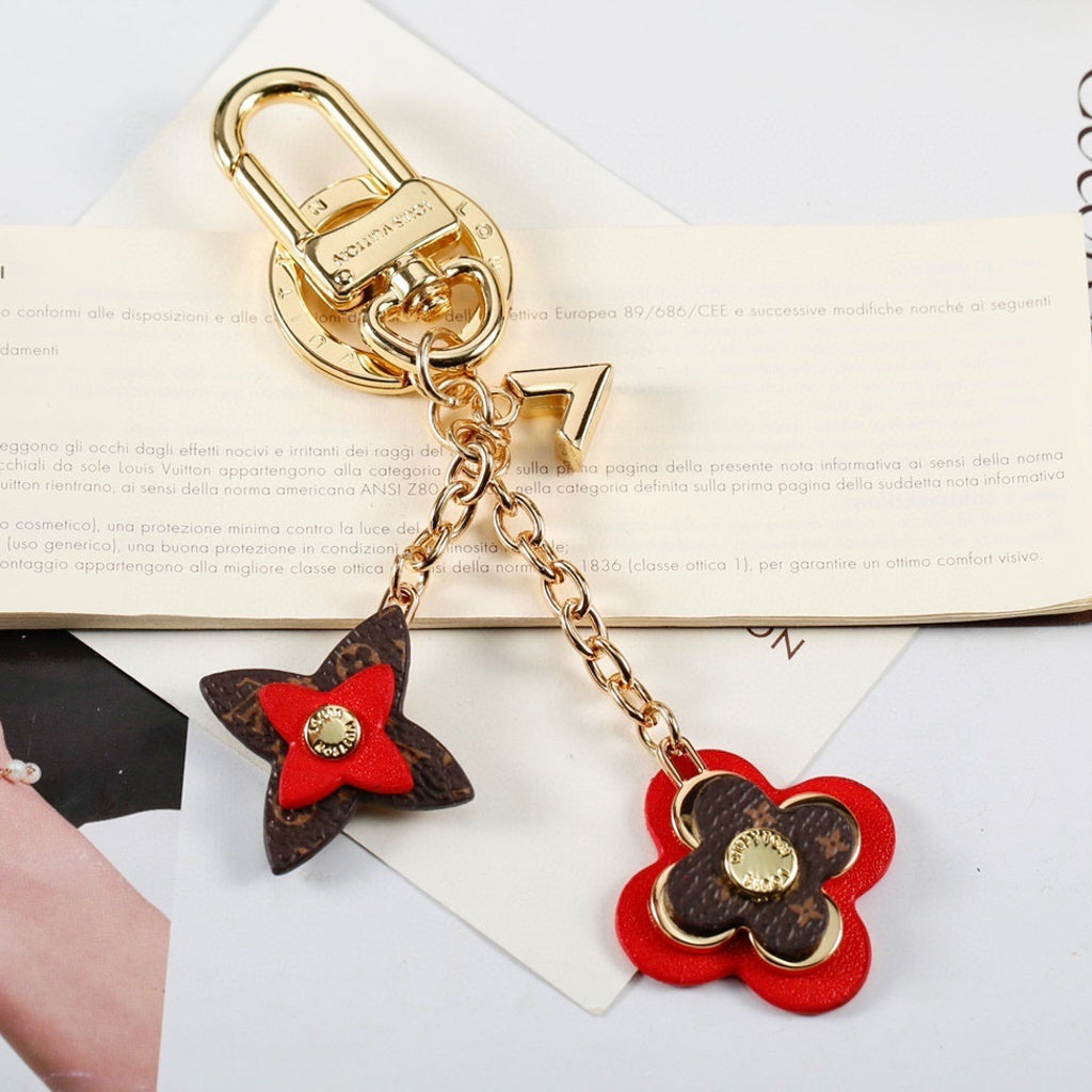 Red monogram flower keychain with gold-tone clasp and chains