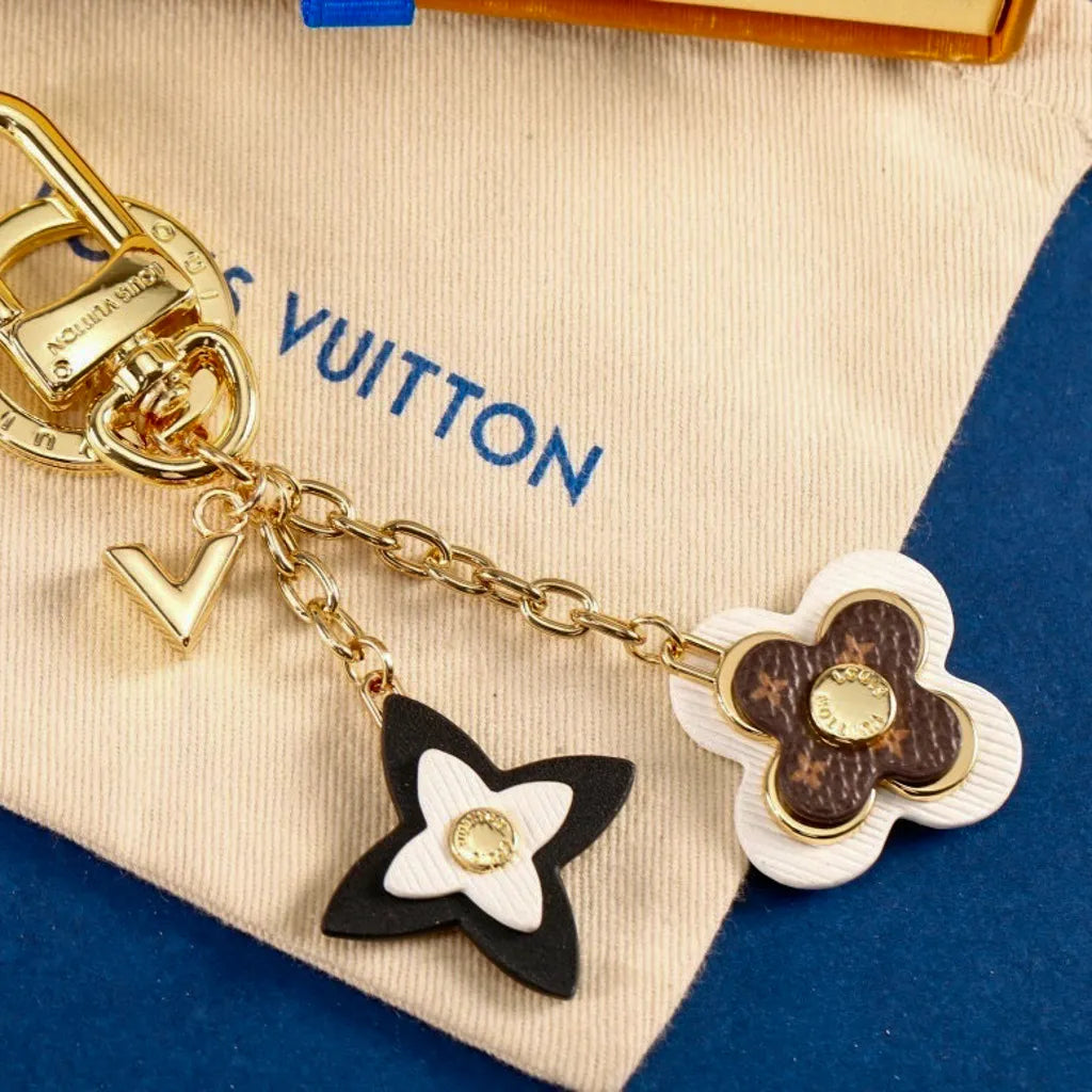 White and dark monogram flower charms on gold-tone chains