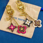 Pink and white floral keychains with gold-tone chains