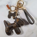 Brown monogram dog keychain with smaller dog charm and wrist strap