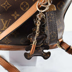 Bear keychain and tassel attached to a monogram bag