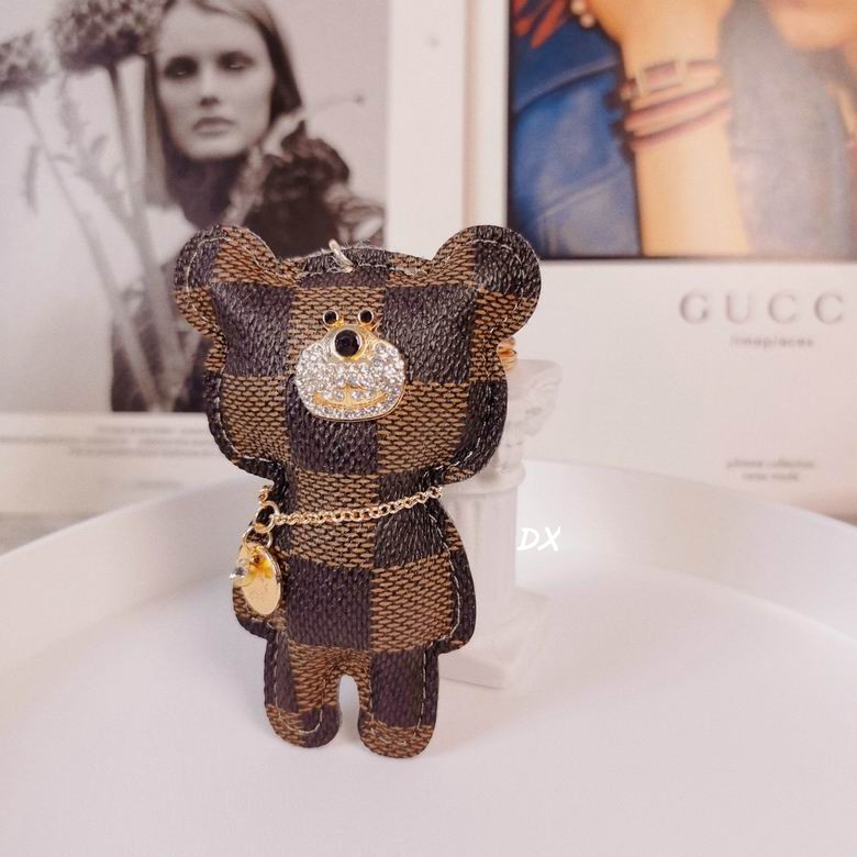 Front view of checkered bear keychain with small hanging pendant