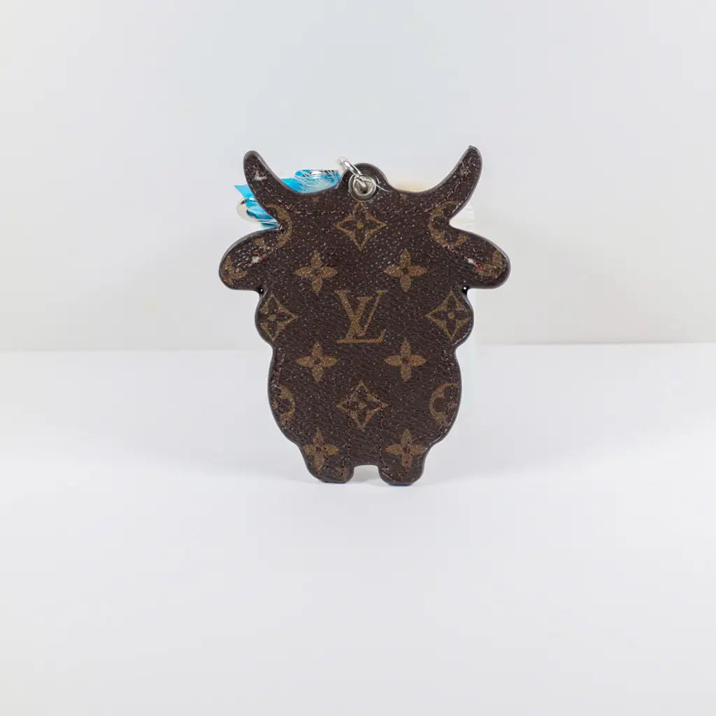 Reverse of brown monogram cow keychain showing its horn silhouette