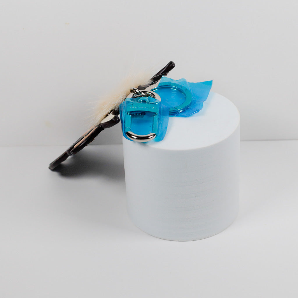 Edge view of slim cow charm with covered metal clasp