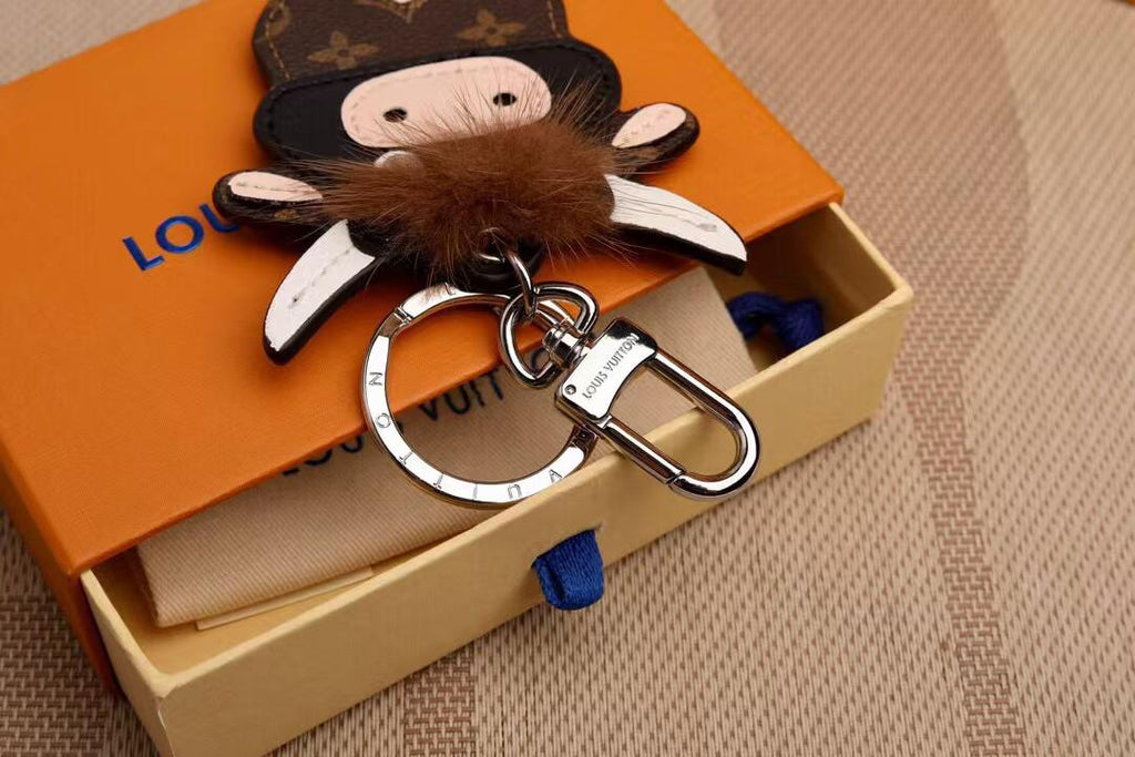 Close-up of cow charm fringe, horns, and silver-tone keyring