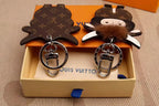 Front and back cow charms displayed together with metal hardware