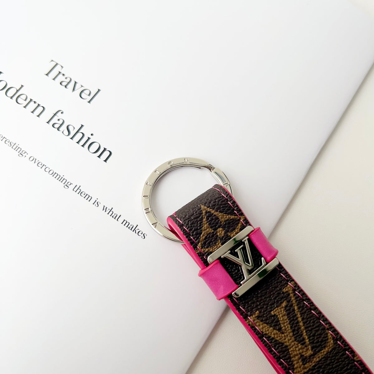 Close-up of pink trim and LV detail on brown strap