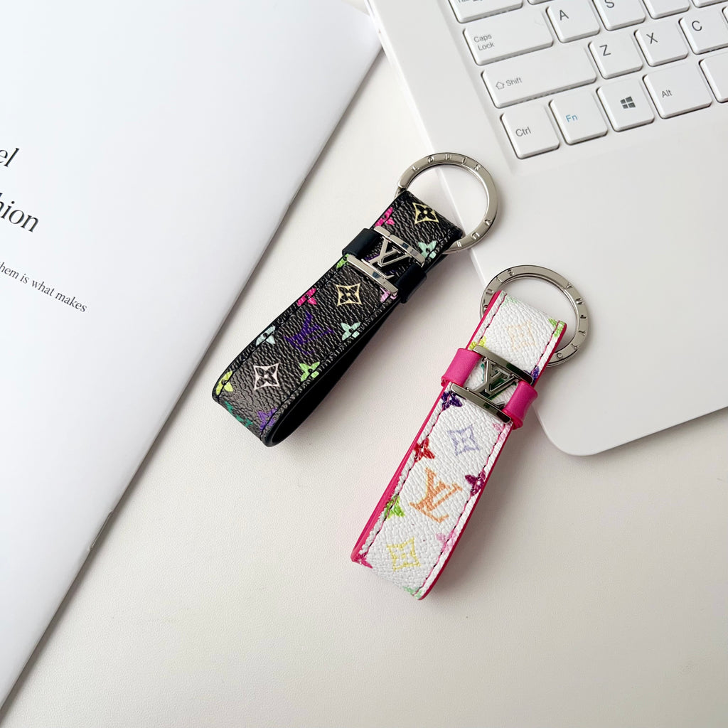 Black and white multicolor monogram key holders beside a keyboard