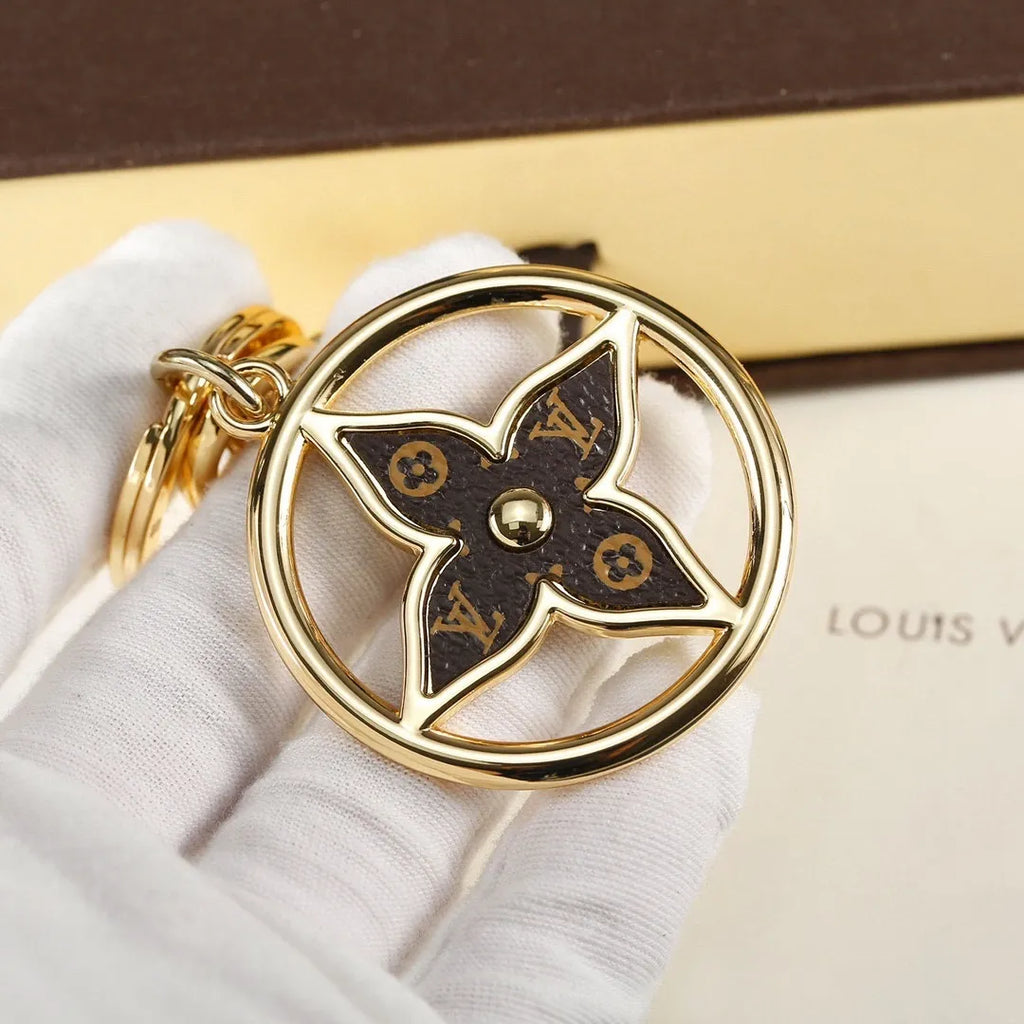 Dark monogram flower pendant held in a white glove