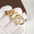Close-up of swivel clasp on gold-tone flower keychain