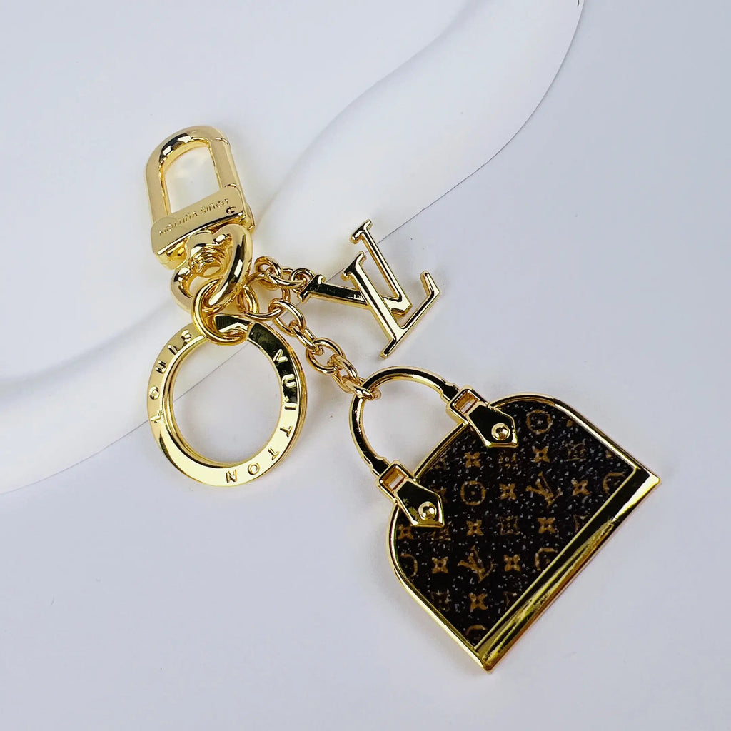 Miniature monogram handbag pendant with gold-tone LV charm