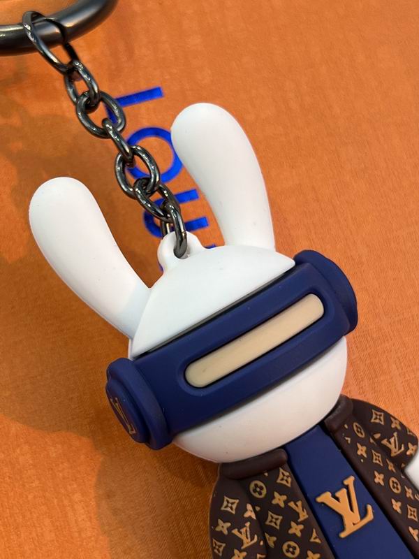 Close-up of bunny keychain head with white ears and blue visor
