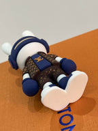 Underside of bunny keychain showing white shoe soles