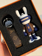Bunny boxer keychain and strap arranged in black box lining