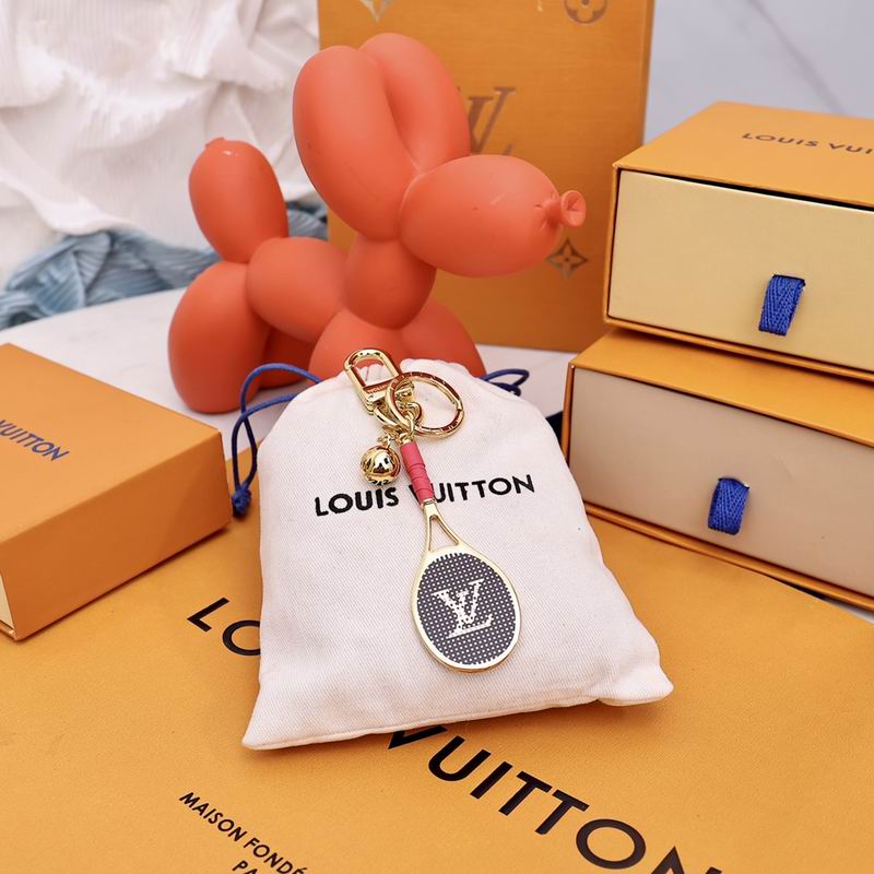 Tennis racket keychain displayed on a cream drawstring pouch