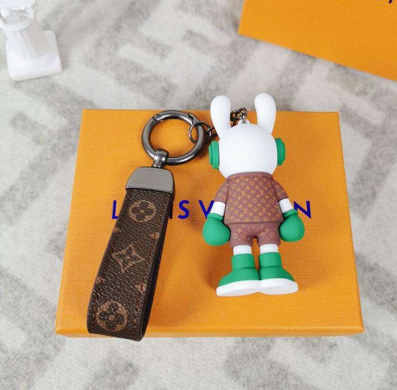 Rear view of green bunny keychain beside brown patterned loop
