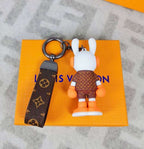 Rear view of orange bunny keychain showing patterned jacket