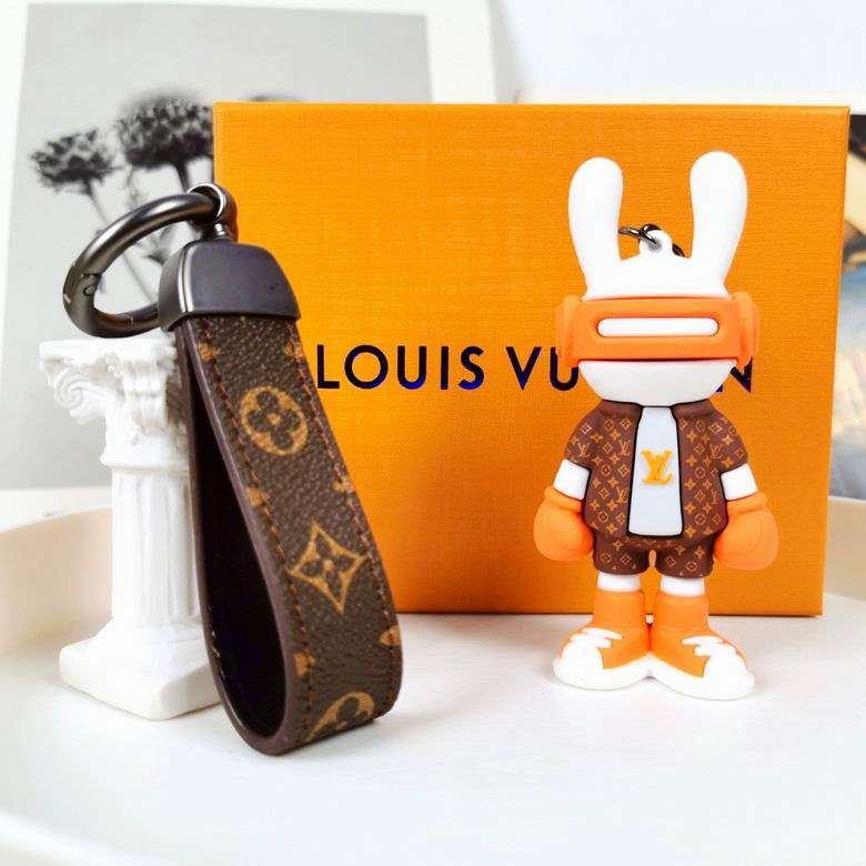Orange bunny boxer keychain beside its brown patterned strap