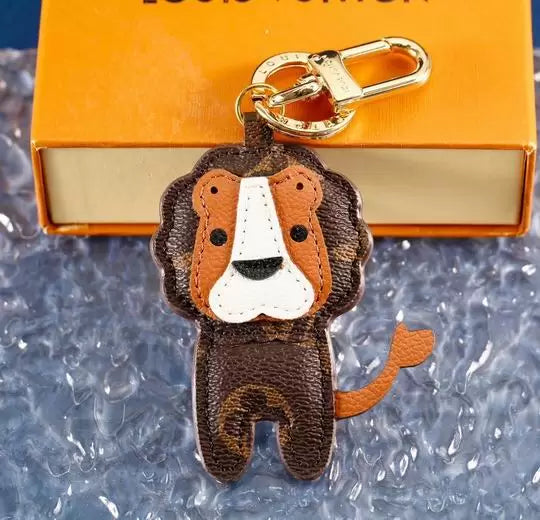 Brown monogram lion keychain with tan mane and gold-tone clasp