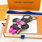 Pink Vivienne keychain displayed on a white card with packaging