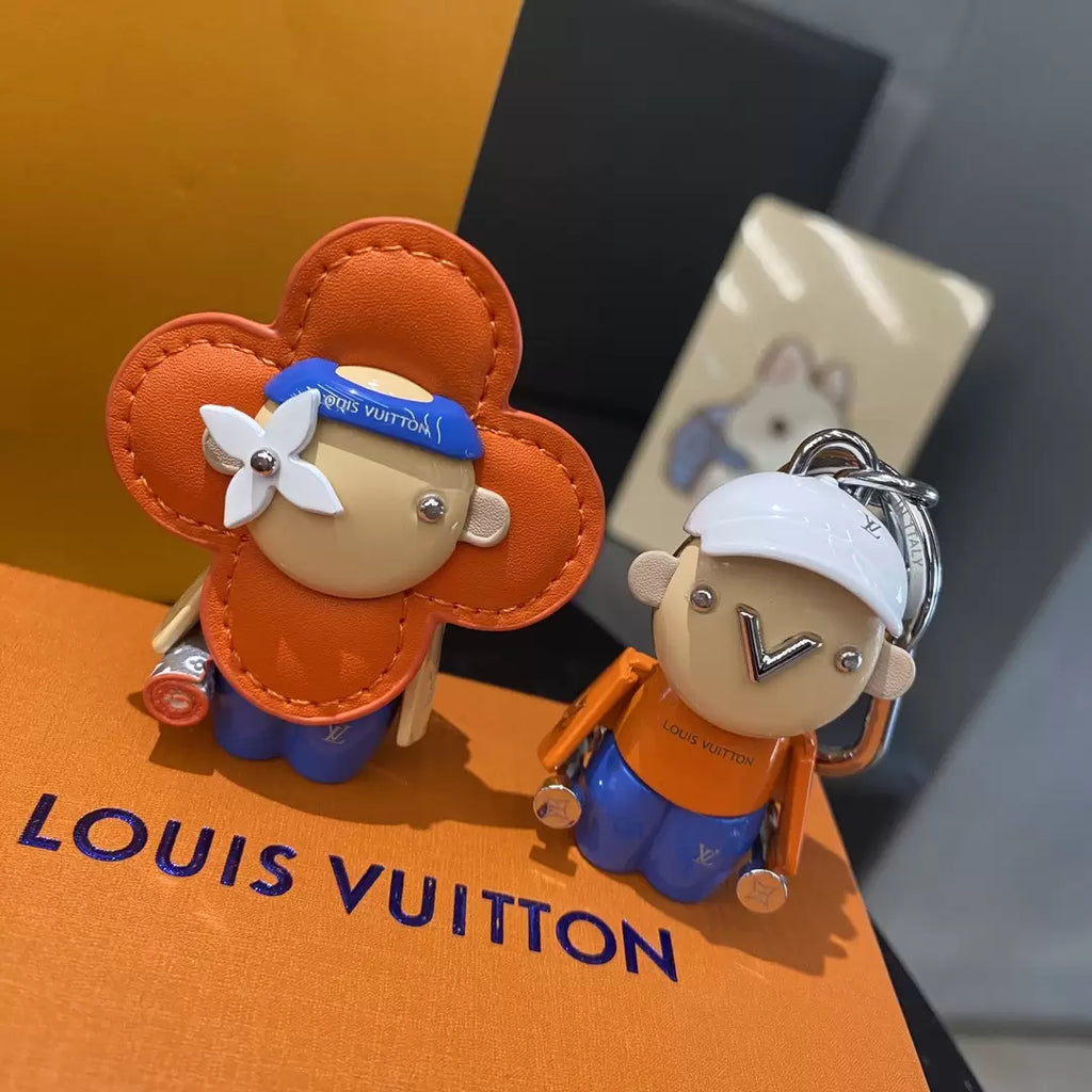 Vivienne Brother keychain displayed beside an orange flower character