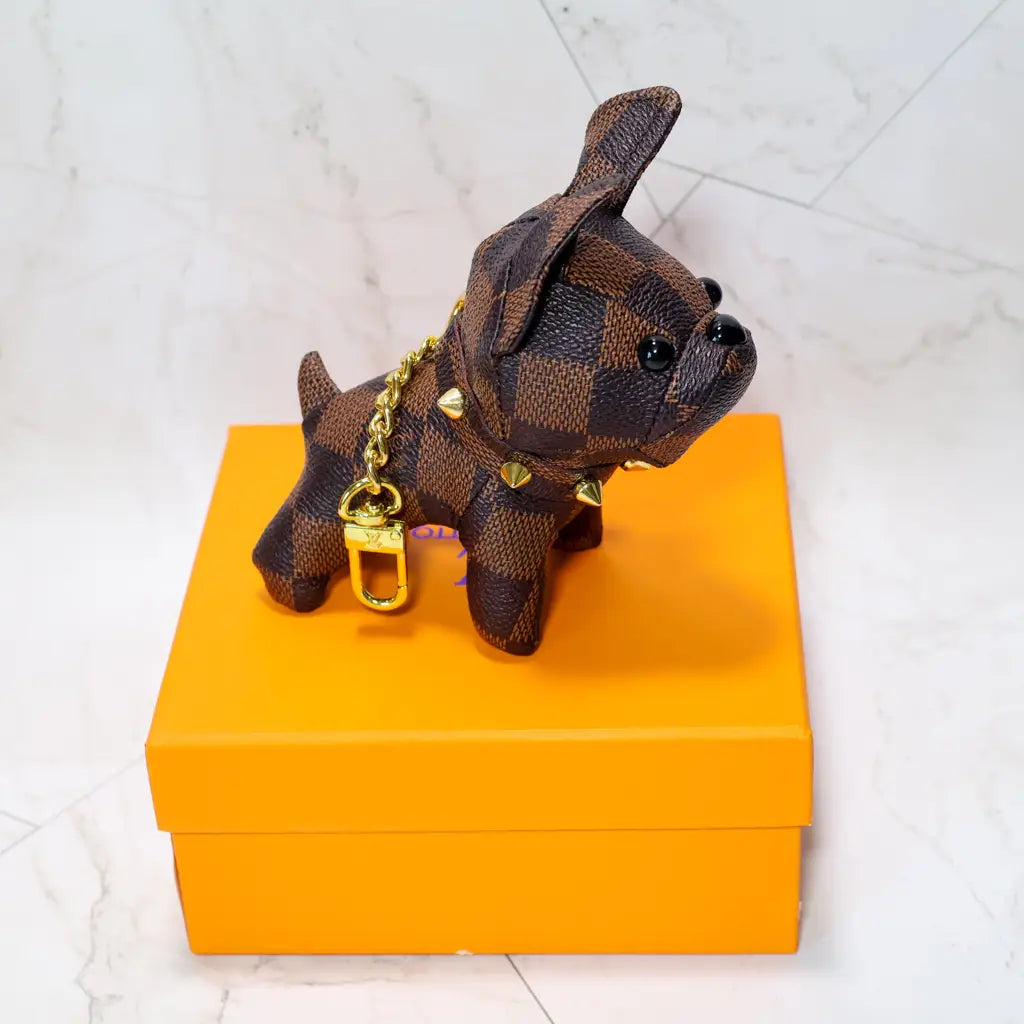 Brown checkered bulldog keychain with upright ears and gold-tone hardware