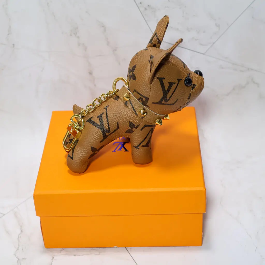 Tan monogram bulldog keychain shown in side profile