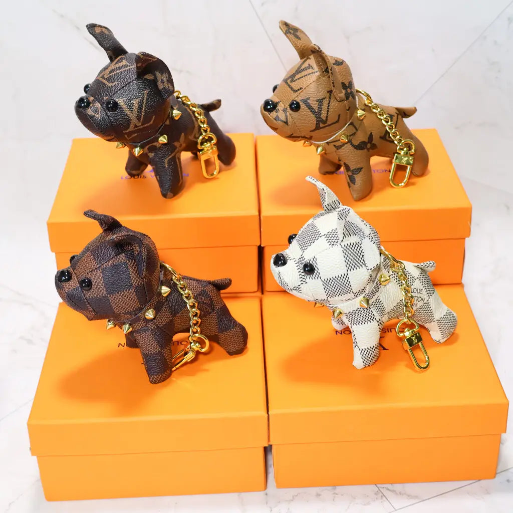 Brown and white patterned bulldog keychains arranged on orange boxes
