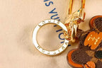 Close-up of engraved gold-tone ring on cat keychain