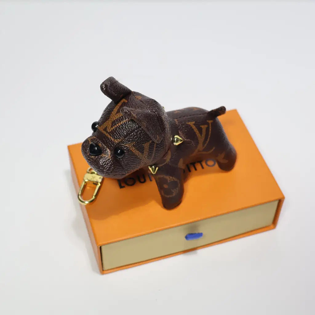 Top view of monogram dog keychain on an orange box