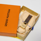Brown folding keychain displayed on a pouch inside a box