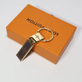 Brown monogram folding keychain with gold-tone hinged hardware
