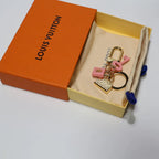 Pink lock-and-key charm set arranged inside an orange box