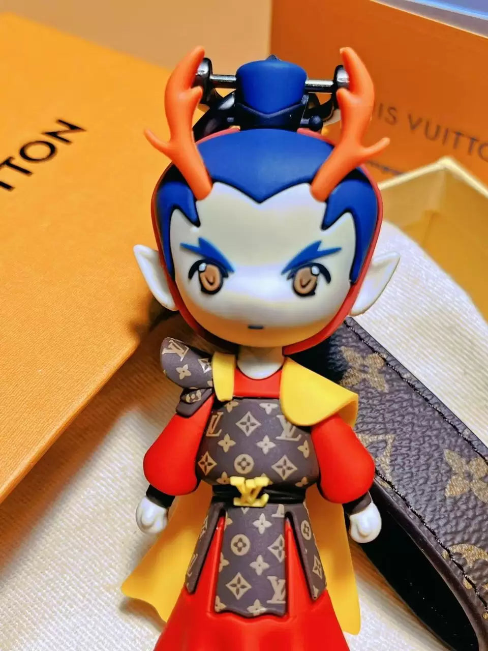 Close-up of Dragon Prince charm with orange horns and red outfit