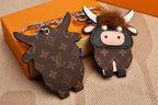 Front and reverse of flat monogram cow charms