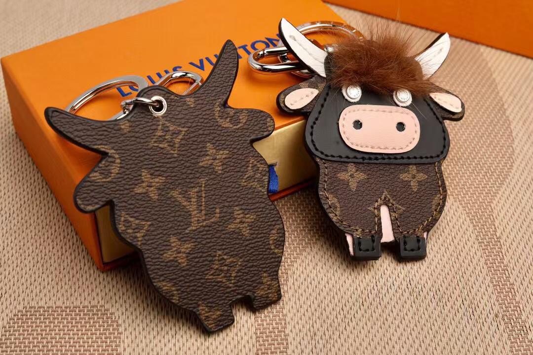 Front and reverse of flat monogram cow charms