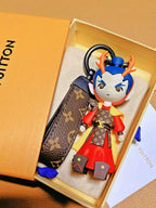Dragon Prince keychain and monogram strap inside an orange box