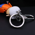Silver-tone keyring and clasp attached behind the character's white cap