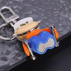 Underside of character keychain showing blue base and silver-tone arms
