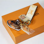Angled view of sneaker charm and cream monogram strap