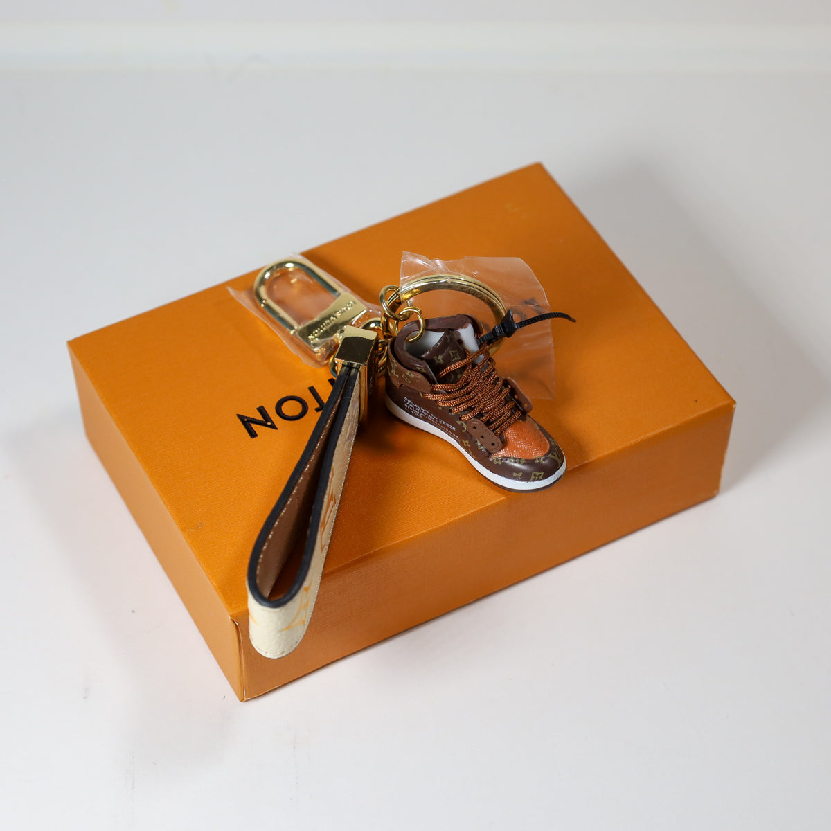Top view of brown sneaker keychain showing dark strap lining
