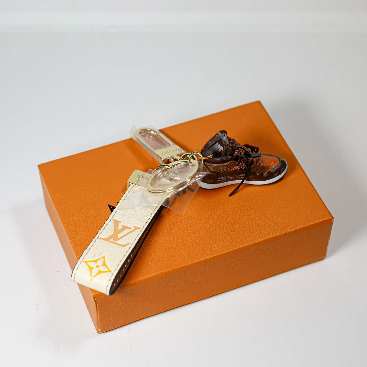 Cream monogram key strap with brown sneaker shown from above