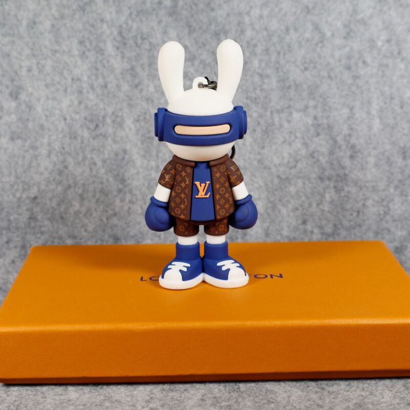 Blue bunny boxer keychain standing on an orange box